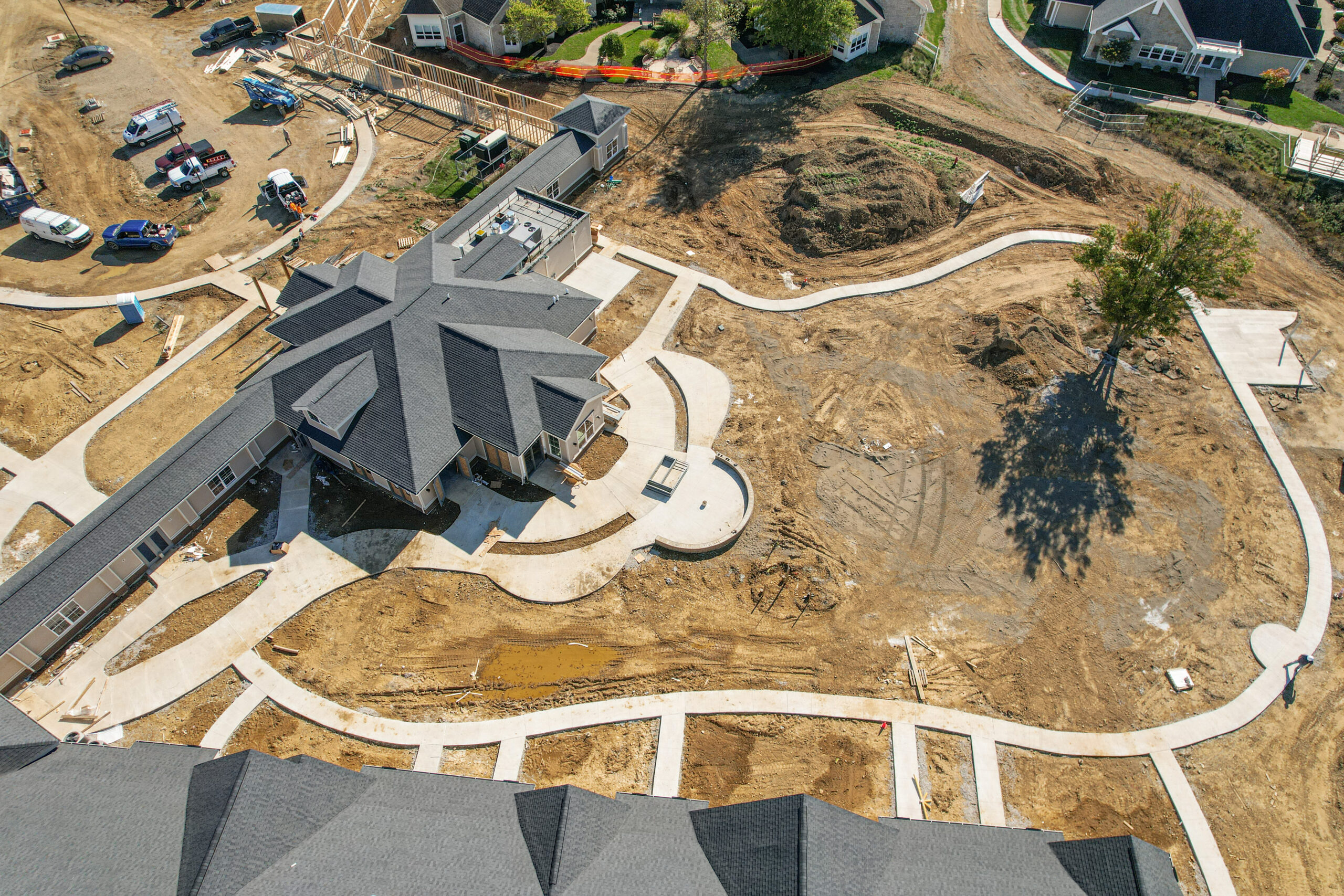 Aerial view of a construction site with a building and landscaping in progress