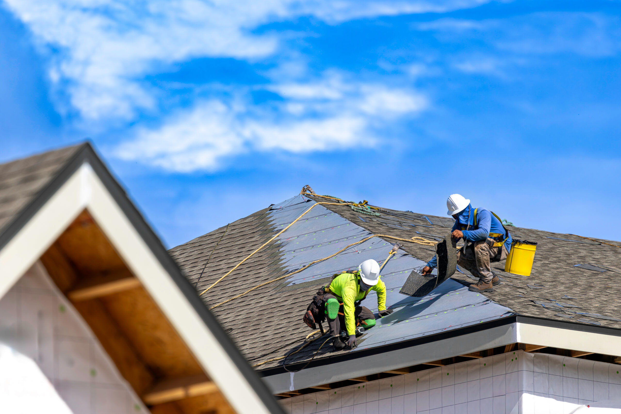 A roofer at work on a residential roof